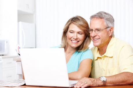 old couple smiling at computer