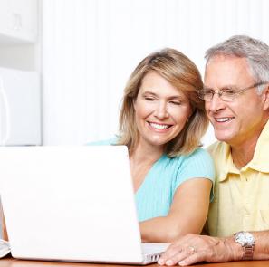 old couple smiling at computer
